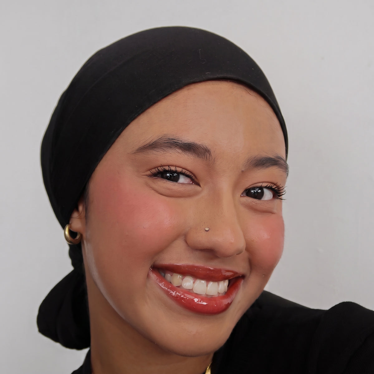 Peptide Glo Lip Oil in Cherry Jam worn on model (2 of 4)