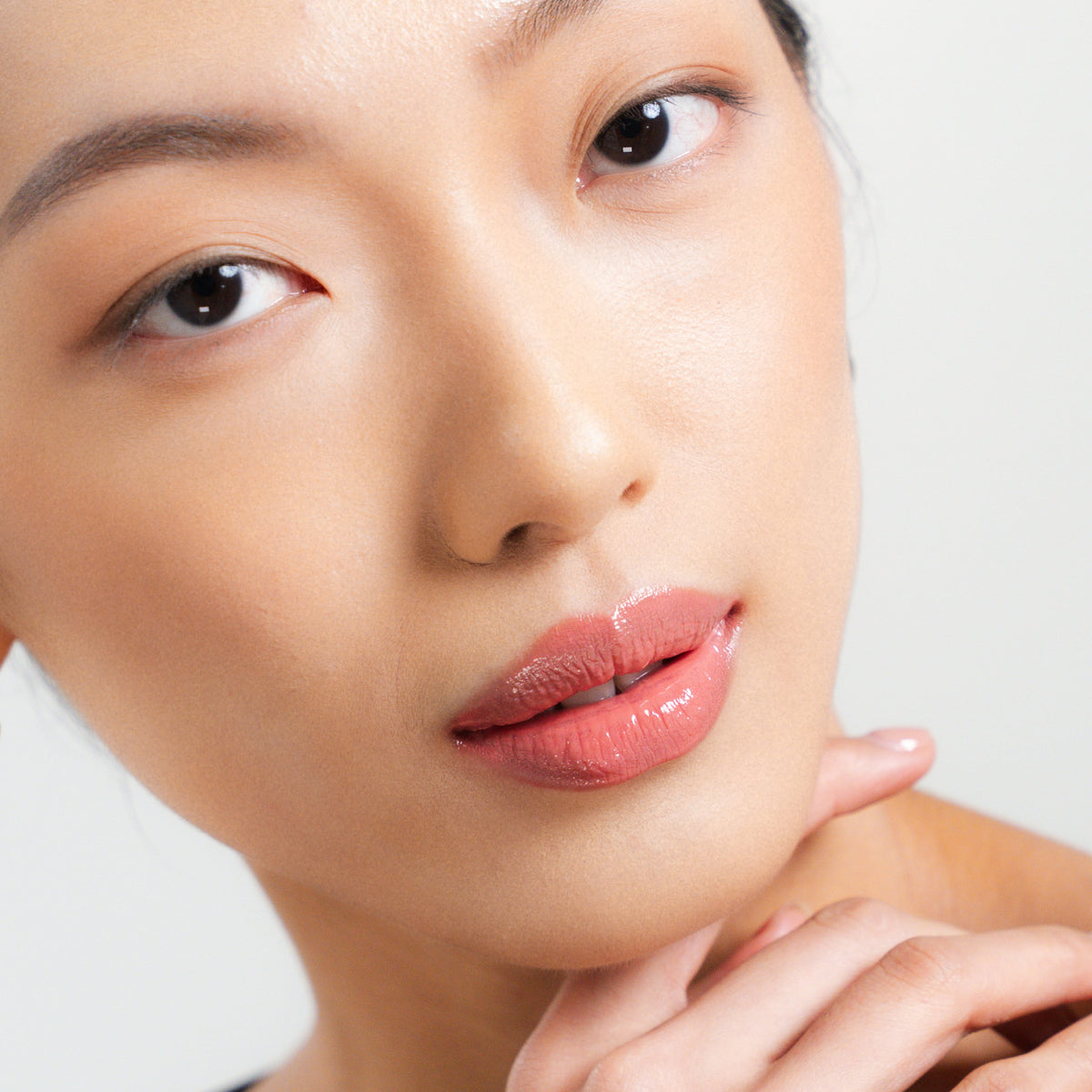 Peptide Glo Lip Glaze in Flirt on fair skin