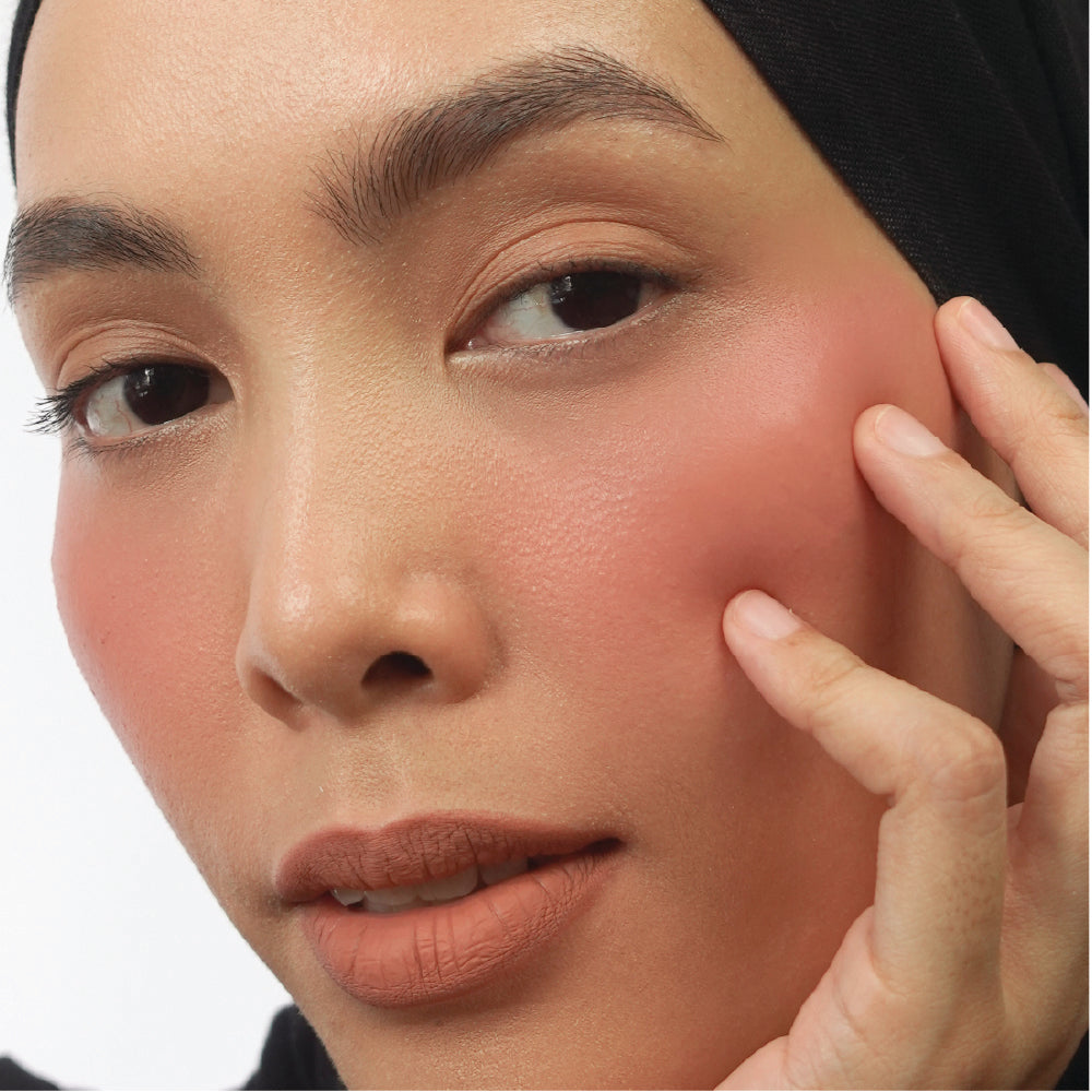 Hyaluronic Liquid Blush in Berry Sweet on medium skin