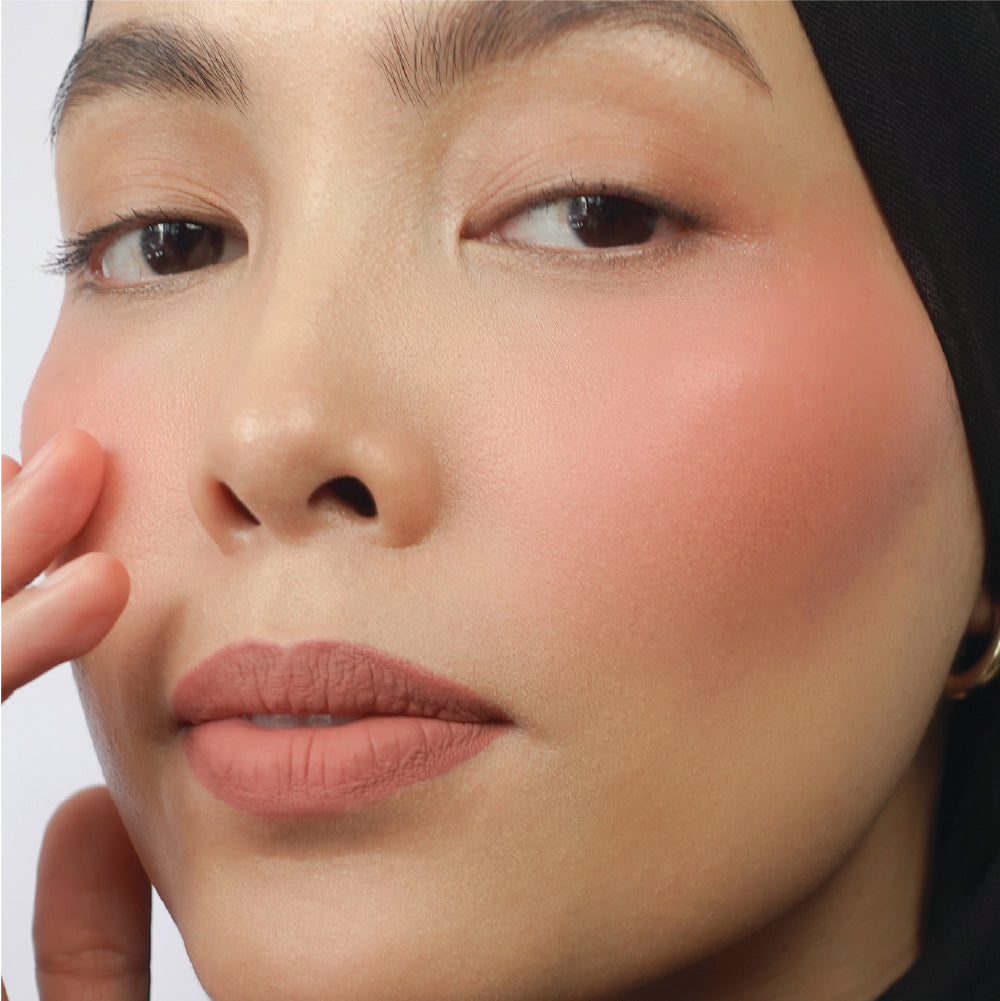 Hyaluronic Liquid Blush in Pinky Promise on medium skin