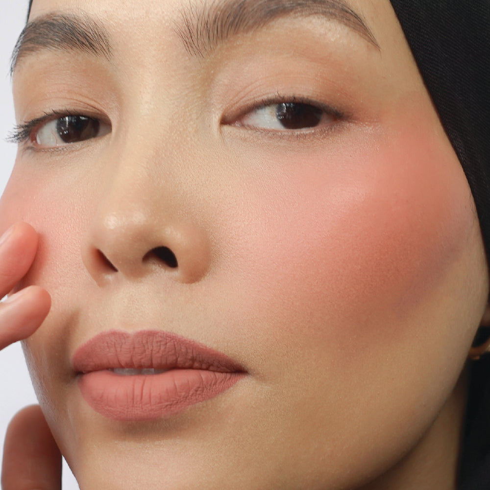 Hyaluronic Liquid Blush in She's That Girl on medium skin