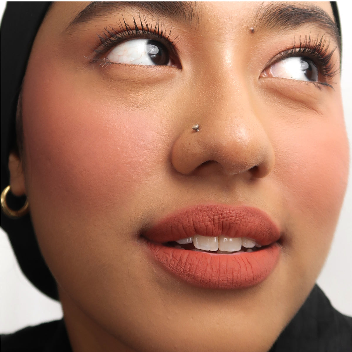 Peptide Hydra-Matte Lipstick in Born Rich on medium skin