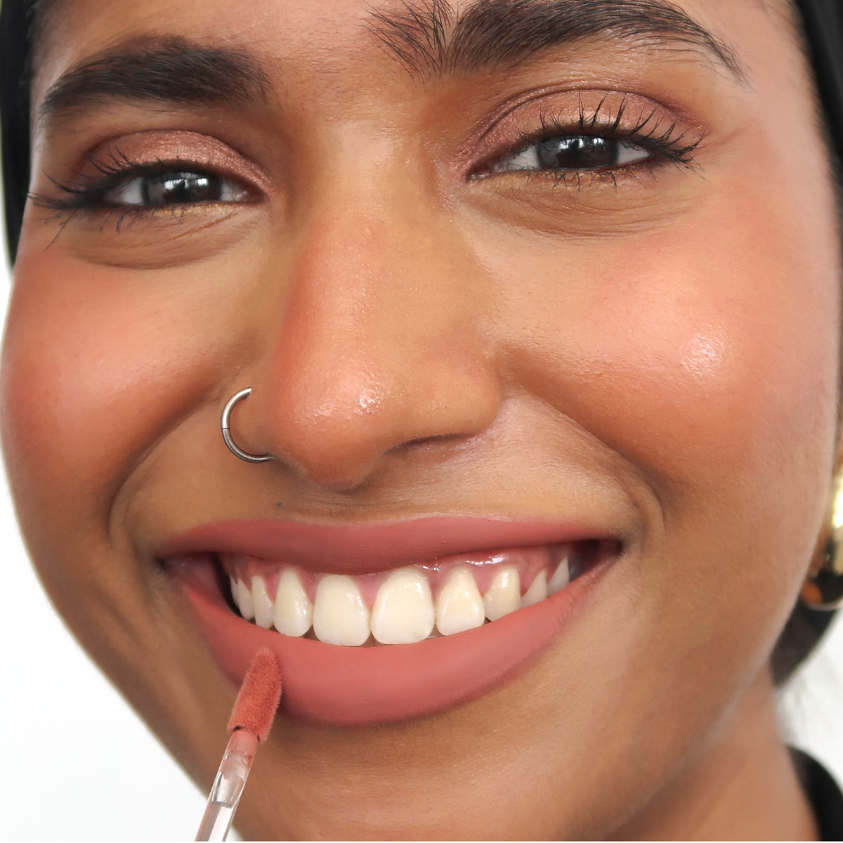 Peptide Hydra-Matte Lipstick in Got Lucky on tan skin