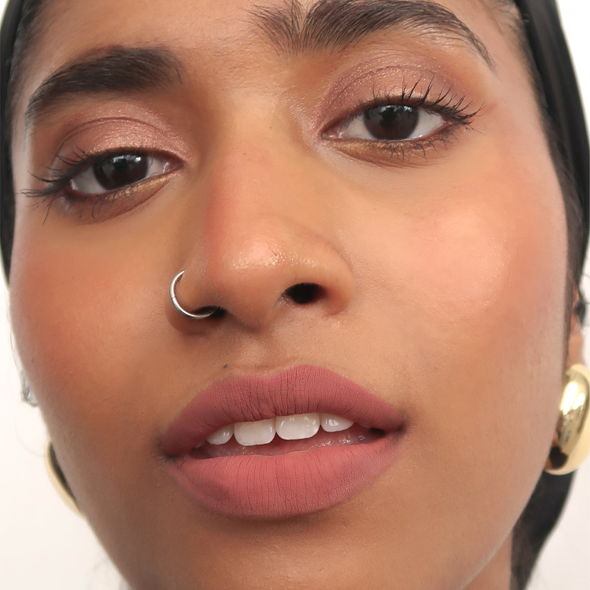 Peptide Hydra-Matte Lipstick in High Profile on tan skin