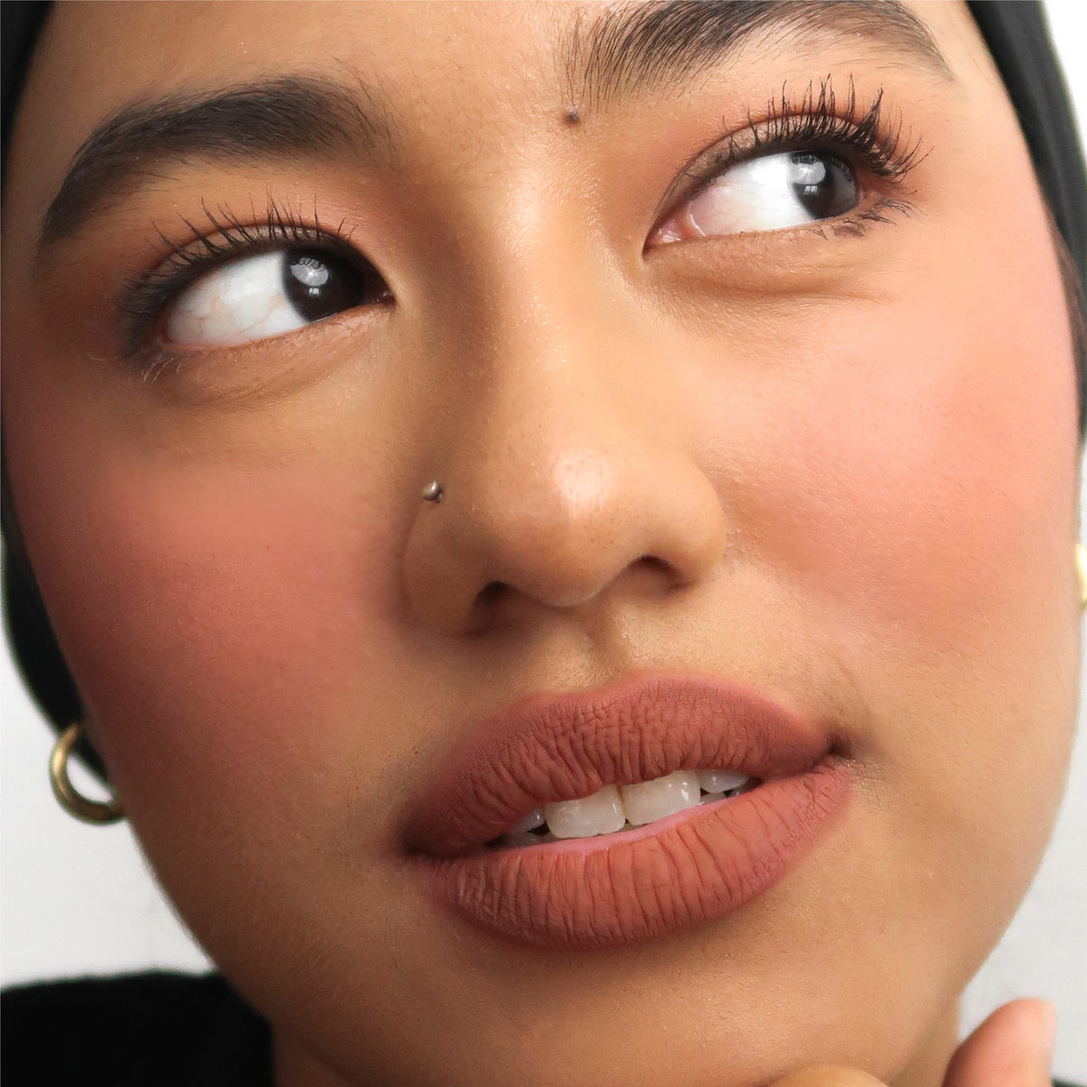 Peptide Hydra-Matte Lipstick in Homegirl on medium skin