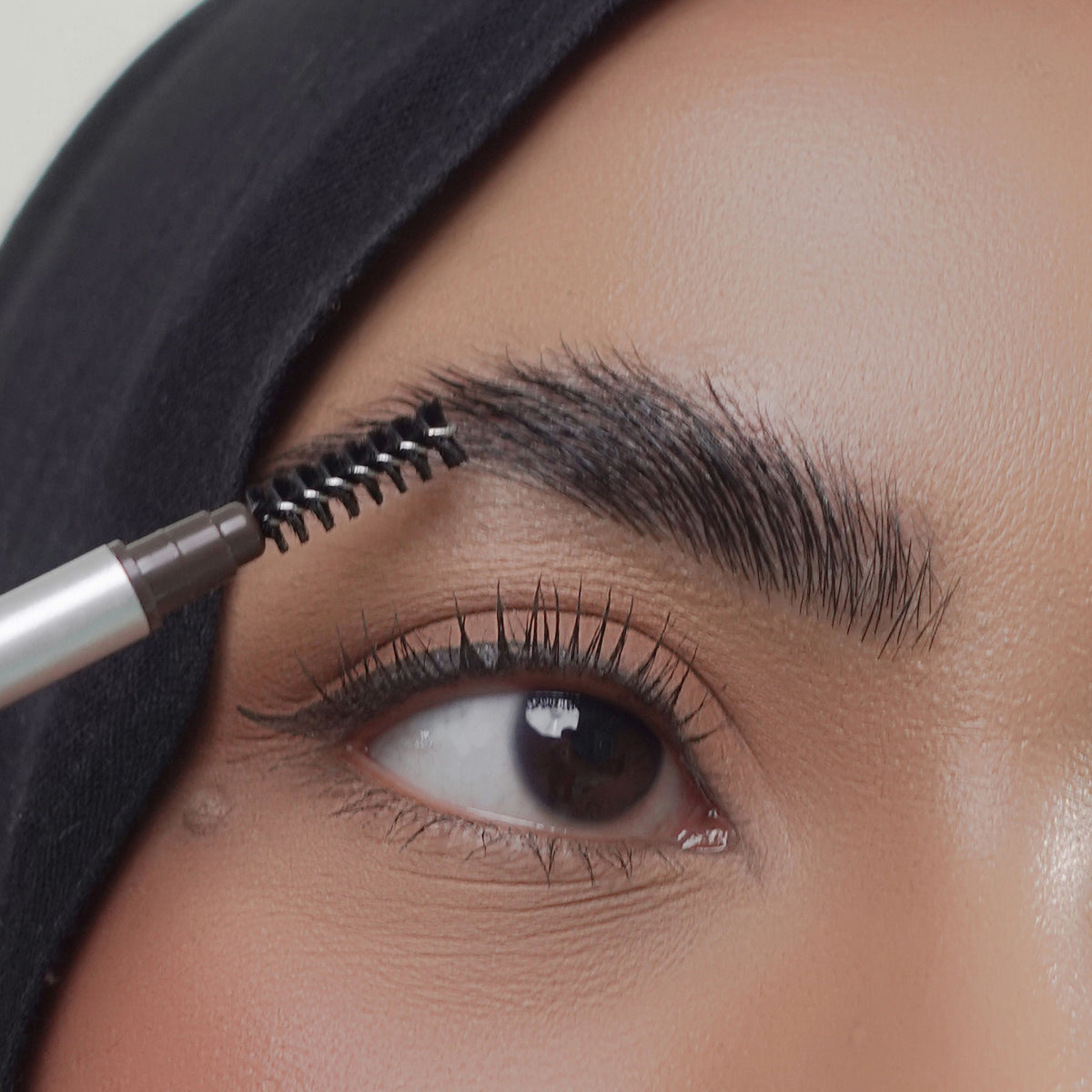 Soft Trace Brow Pencil in Dark Brown on tan skin