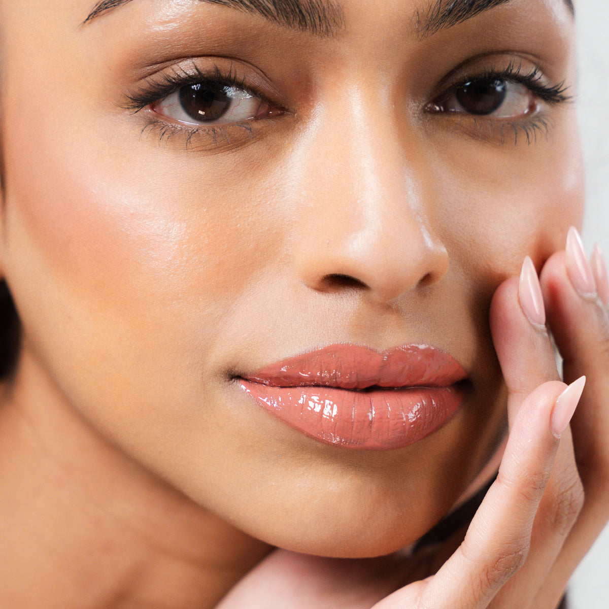 Peptide Glo Lip Glaze in Sway on tan skin