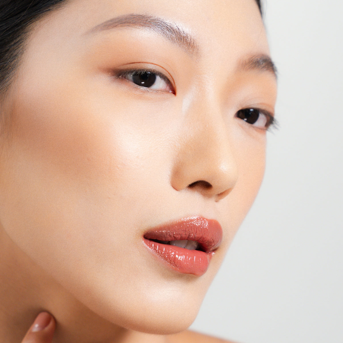 Peptide Glo Lip Glaze in Veil on fair skin